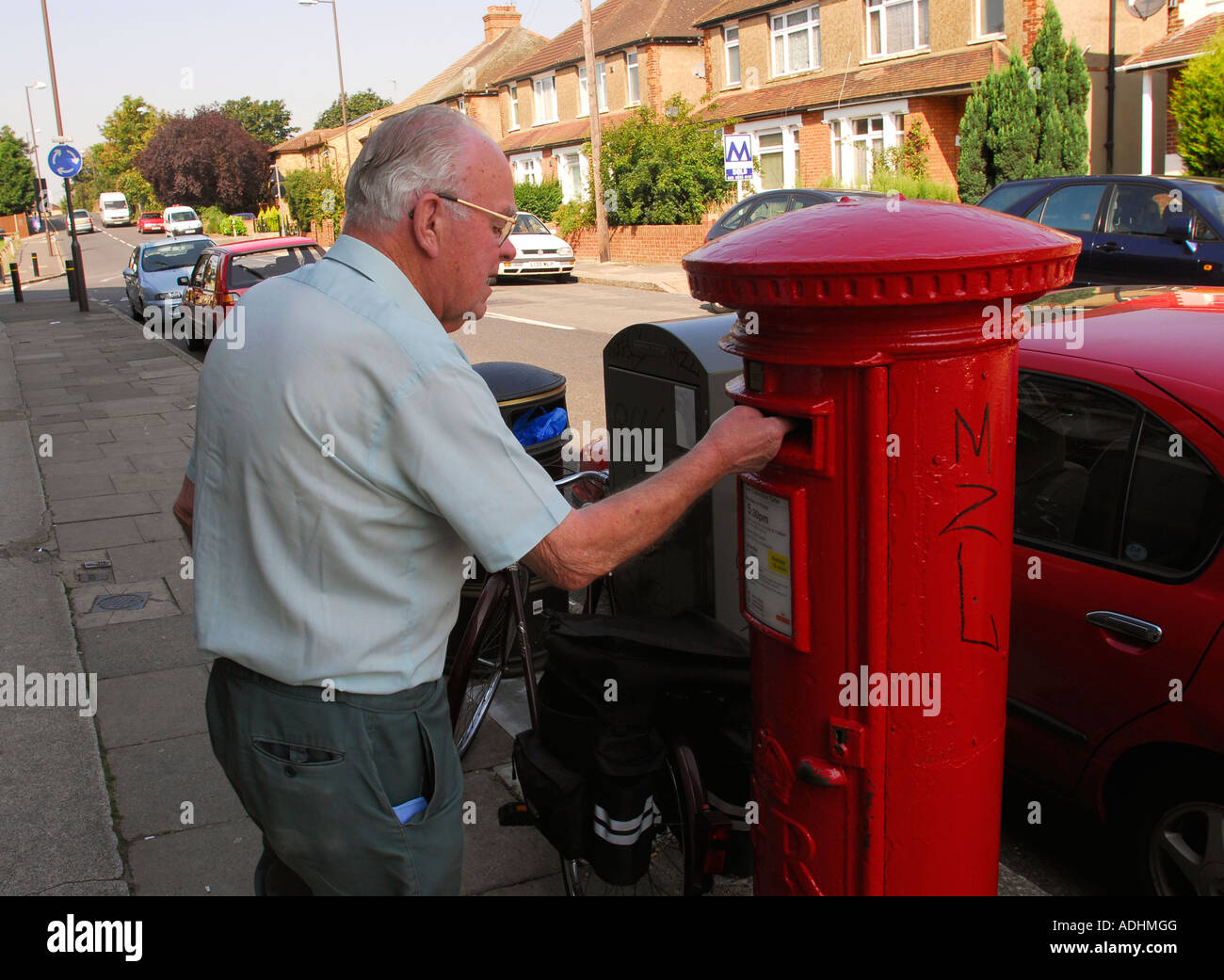 Elderly man posting a letter Hounslow Middlesex UK Stock Photo