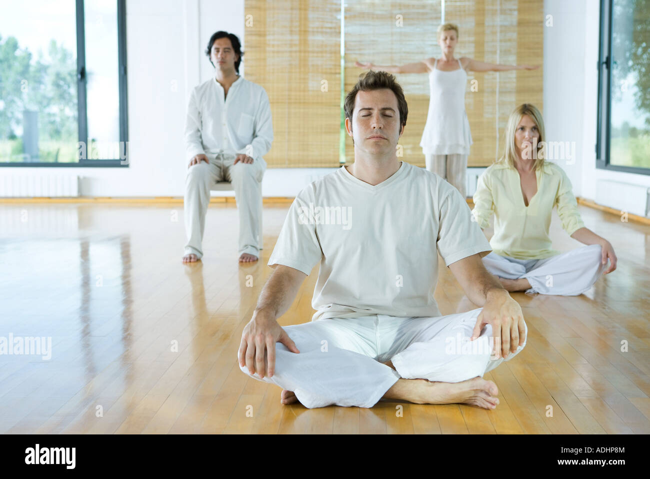 Group meditation, adults sitting in different positions Stock Photo Alamy