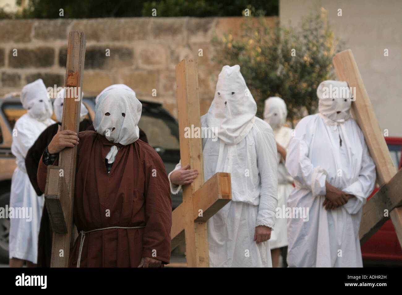 Eastertime penitents bearing crosses in Nadur, Gozo, Malta. Catholic religious traditions, faith, Christianity, sin, atonement and redemption. Stock Photo