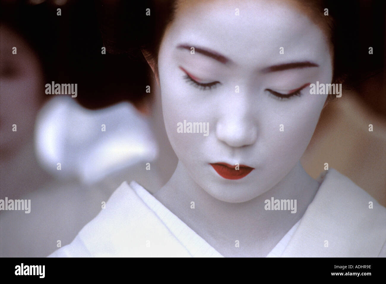 Close up of a shy pensive maiko or apprentice geisha with powder white face Stock Photo