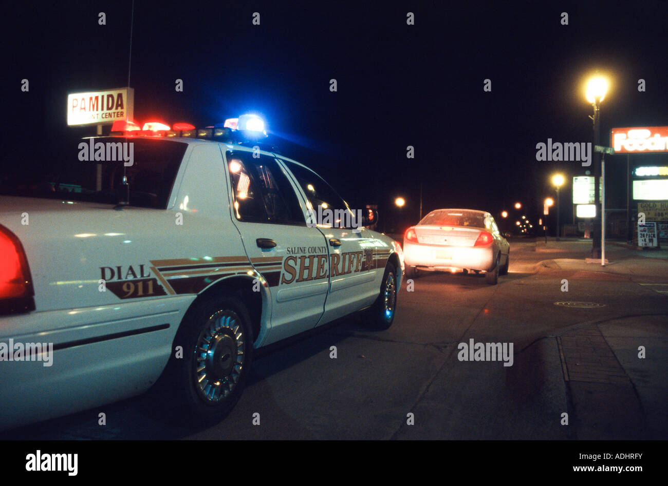 Deputy sheriff making sobriety check point late at night. Driver was arrested for DUI. Nebraska, USA. Stock Photo