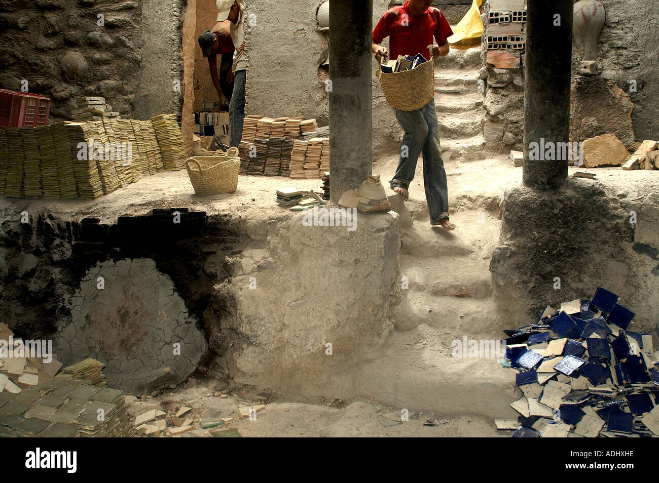 Removing the tiles from the kiln after firing the glaze at the ceramic