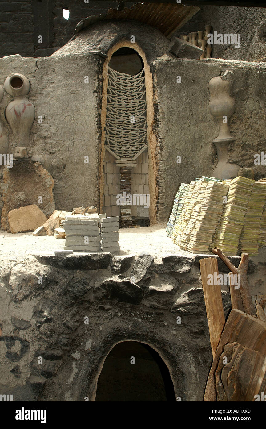 A stack of tiles for firing above the kiln at the ceramic clay works in