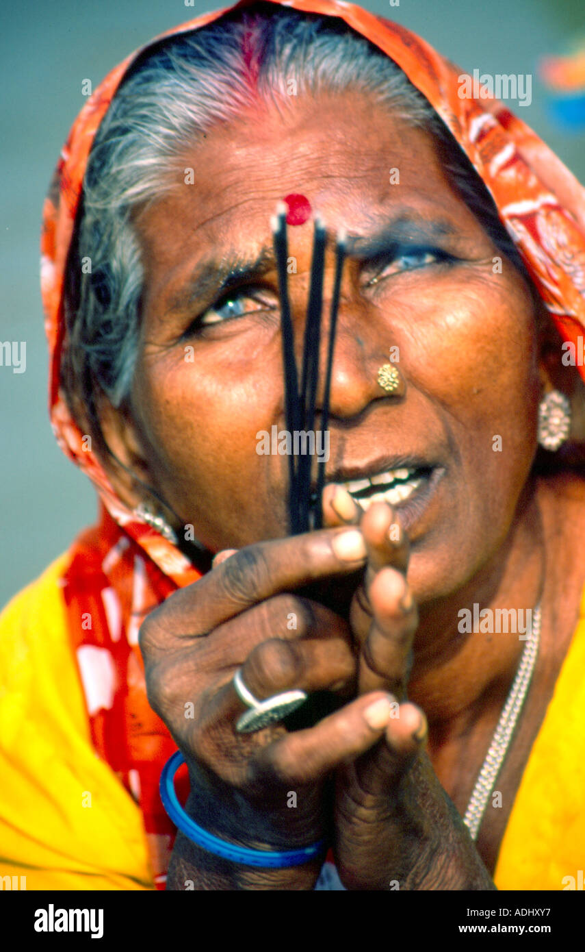 A blind Hindu woman makes an offering to the Sun-God Stock Photo