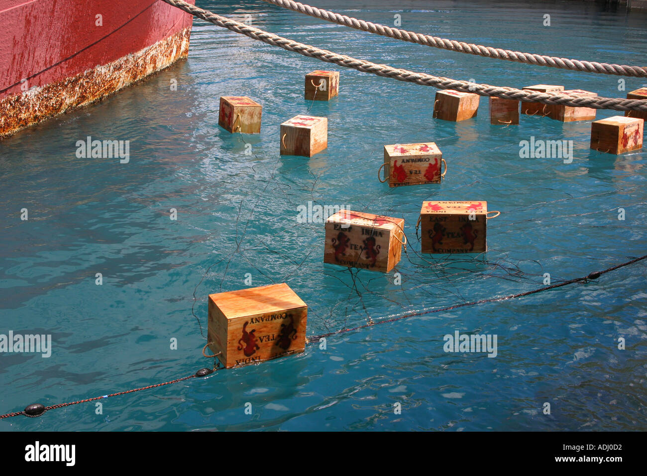 Boxes of tea floating in harbor during a Boston Tea Party reenactment Stock Photo
