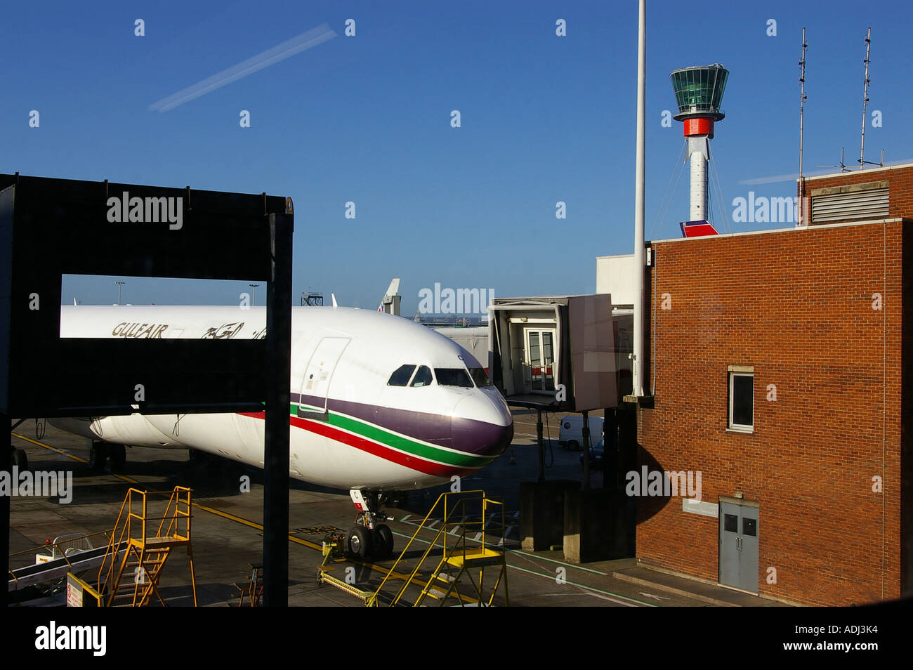 Heathrow airport runway parked Gulf Air airplane Stock Photo