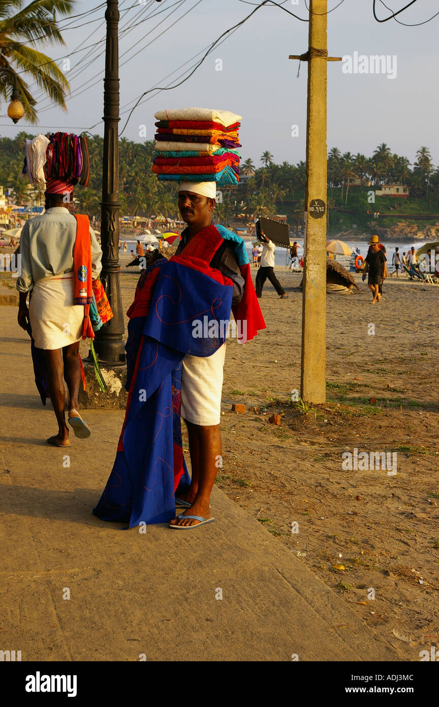 Indian man selling sarongs Kovalam beach Stock Photo