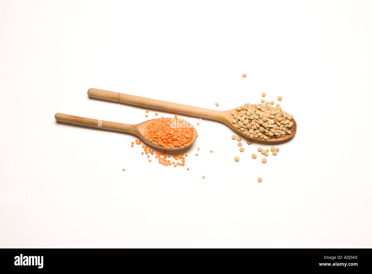 Lentils on wooden spoons Stock Photo