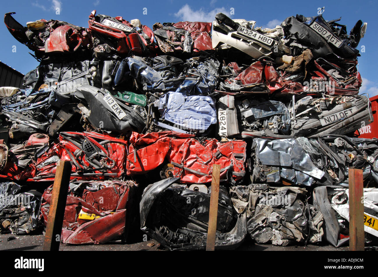 Cubes of crushed cars stand in a huge pile at a car recycling and salvage yard Stock Photo Alamy