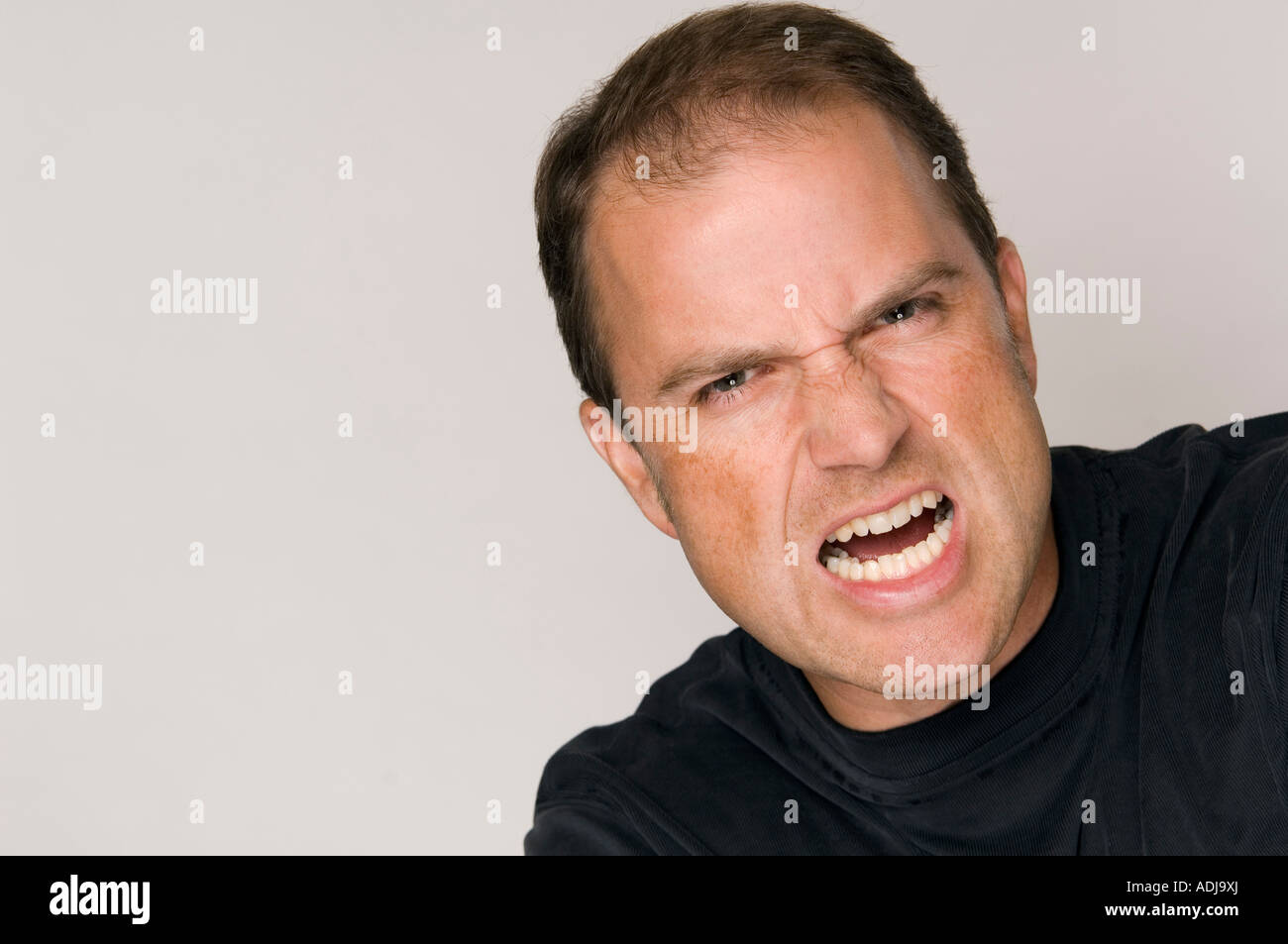 Close up of angry man's face yelling. Stock Photo