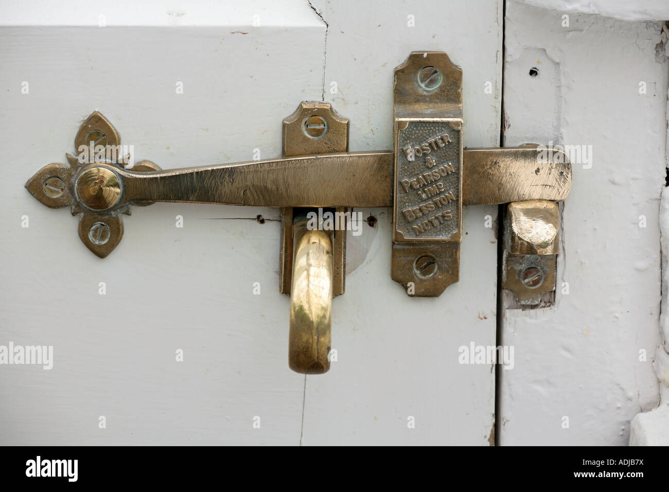 Brass door latch on white painted door, made by Foster and Pearson of Beeston, Notts Stock Photo