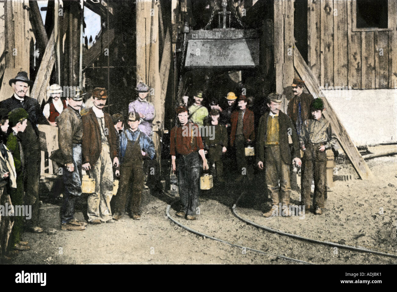 Coal miners emerging from the mine shaft after their nine hours of toil are ended in the early 1900s. Hand-colored halftone of a photograph Stock Photo