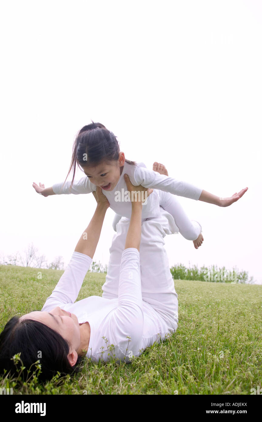 a mother and a child doing Yoga Stock Photo - Alamy