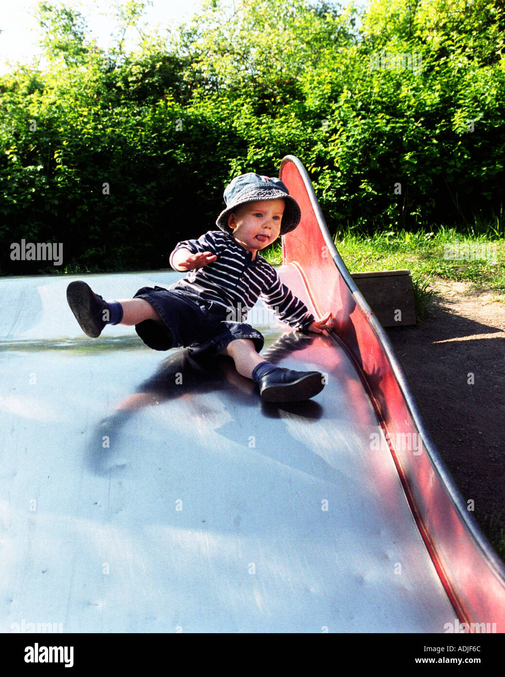 Small Kid Going Down The Slide Stock Photo Alamy