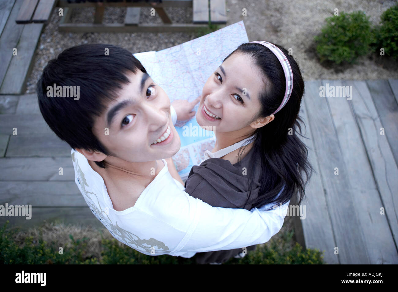 happy married couple look above with map in ther honeymoon Stock Photo
