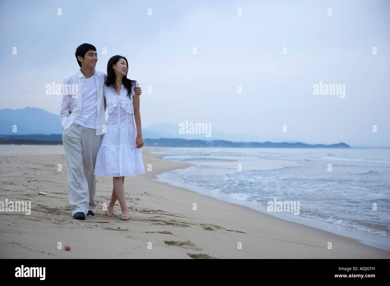 Asian couple walking on sandy hi-res stock photography and images - Alamy