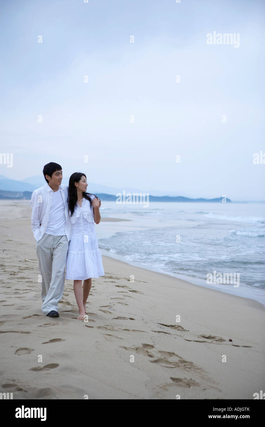 Asian couple walking on sandy hi-res stock photography and images - Alamy
