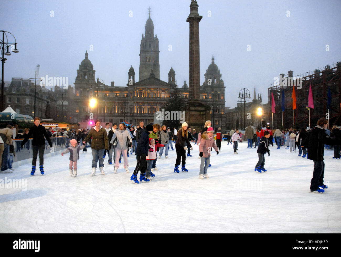 Ice Skating on Outdoor Ice Rink, Square. City Chambers in