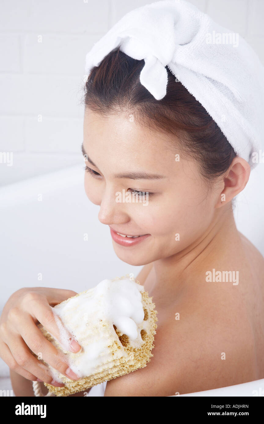 woman scrubbing her body with sponge Stock Photo Alamy