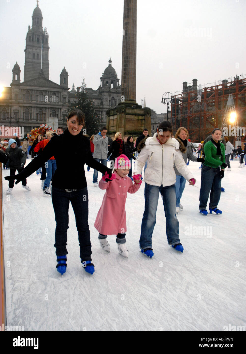 Ice Skating on Outdoor Ice Rink, Square. City Chambers in
