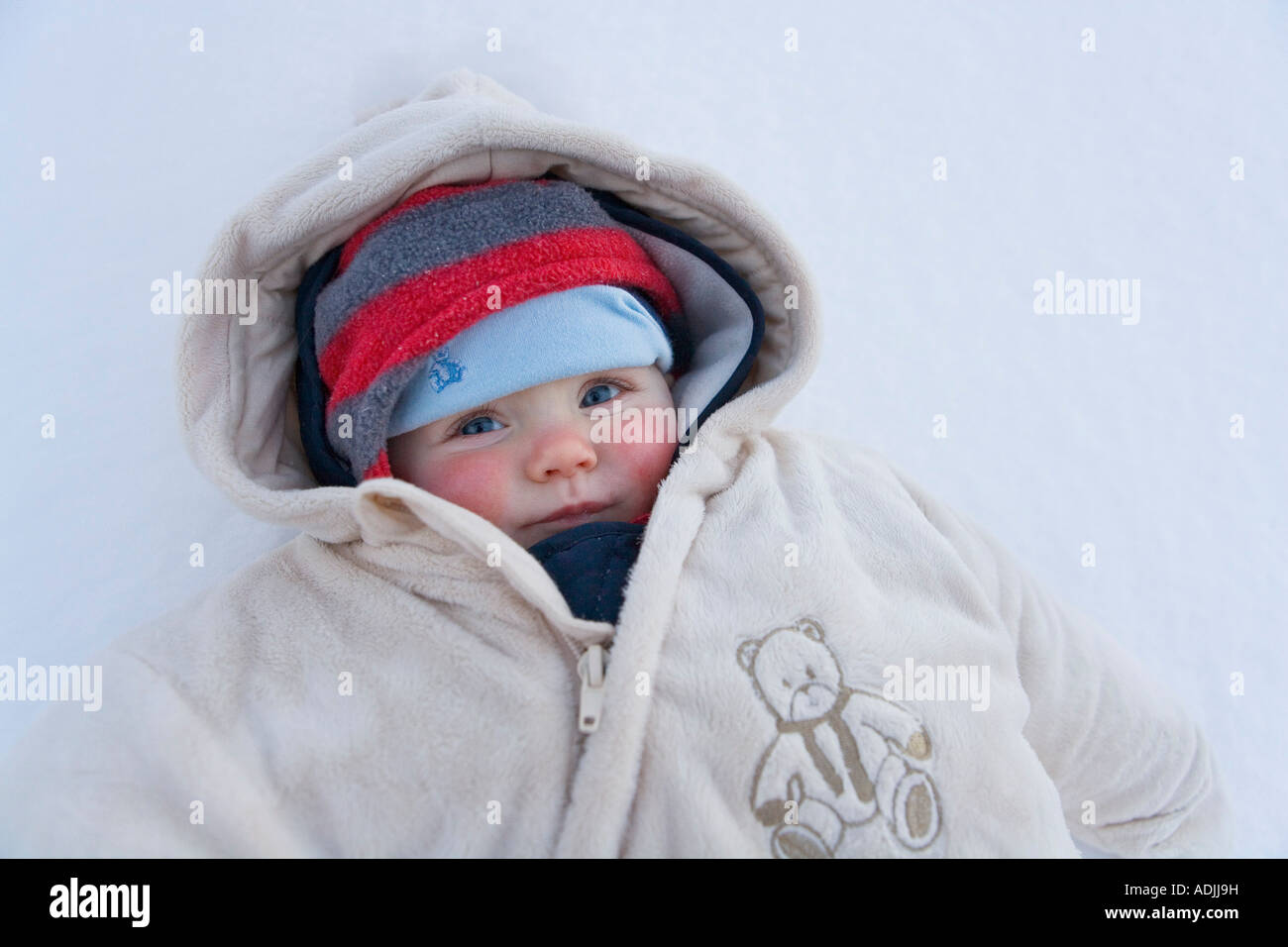 Closeup portrait of infant girl with rosy cheeks dressed for cold weather Southcentral Alaska