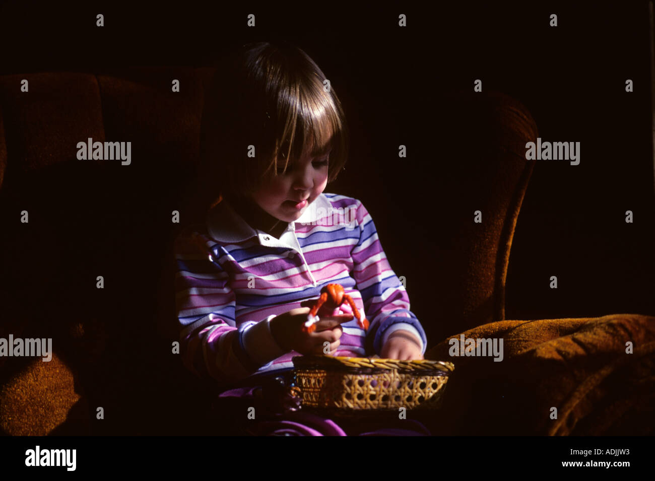 Girl paying with dolls Stock Photo