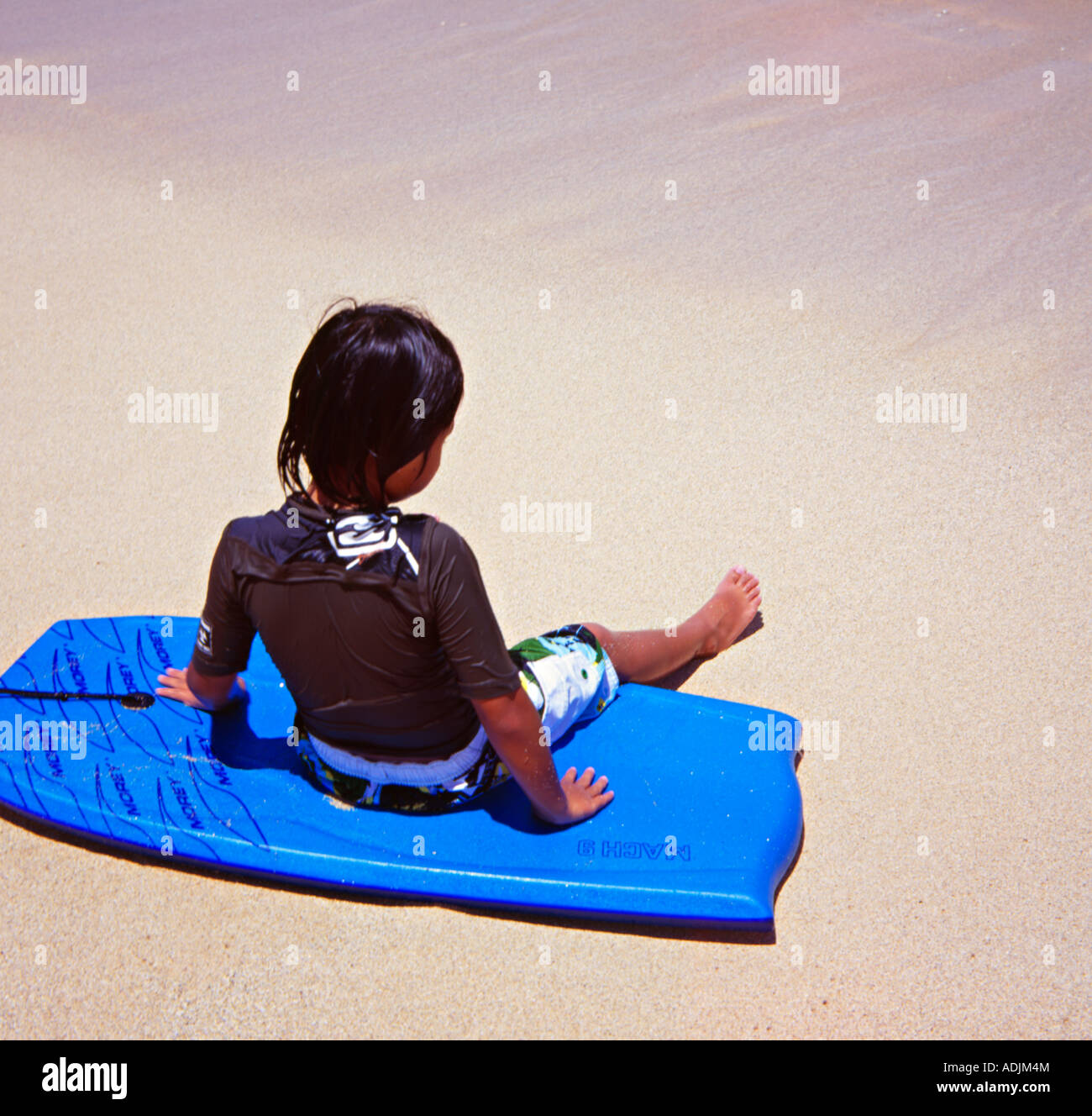 Little Girl on Boggie Board, Waikiki beach, Oahu, Hawaii Stock Photo