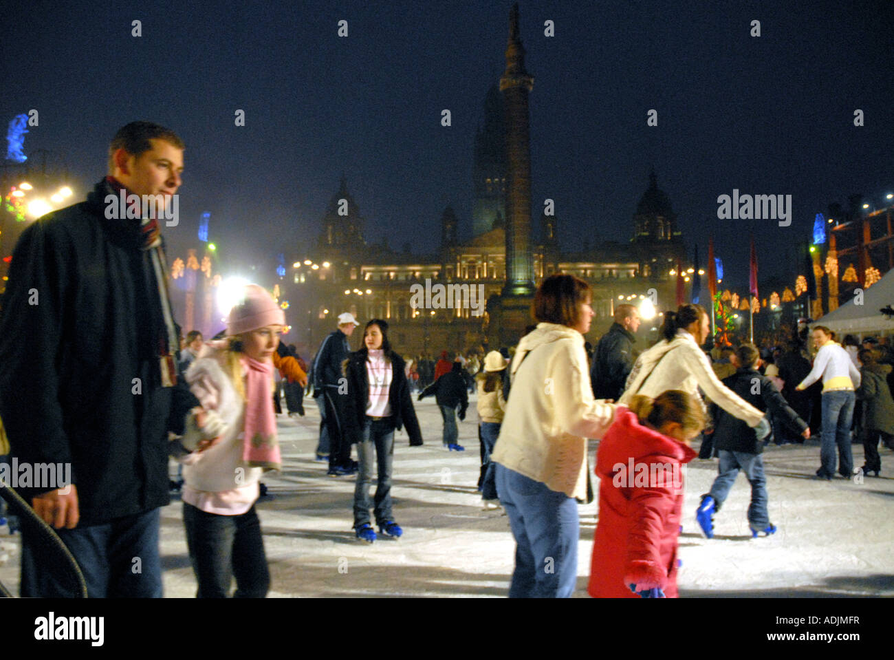 Ice Skating on Outdoor Ice Rink, Square. City Chambers in