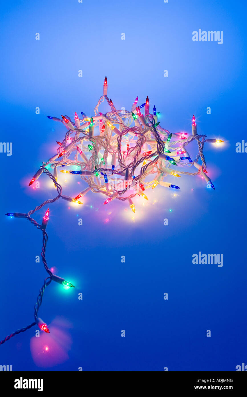 One strand of multi colored Christmas tree lights coiled together with
