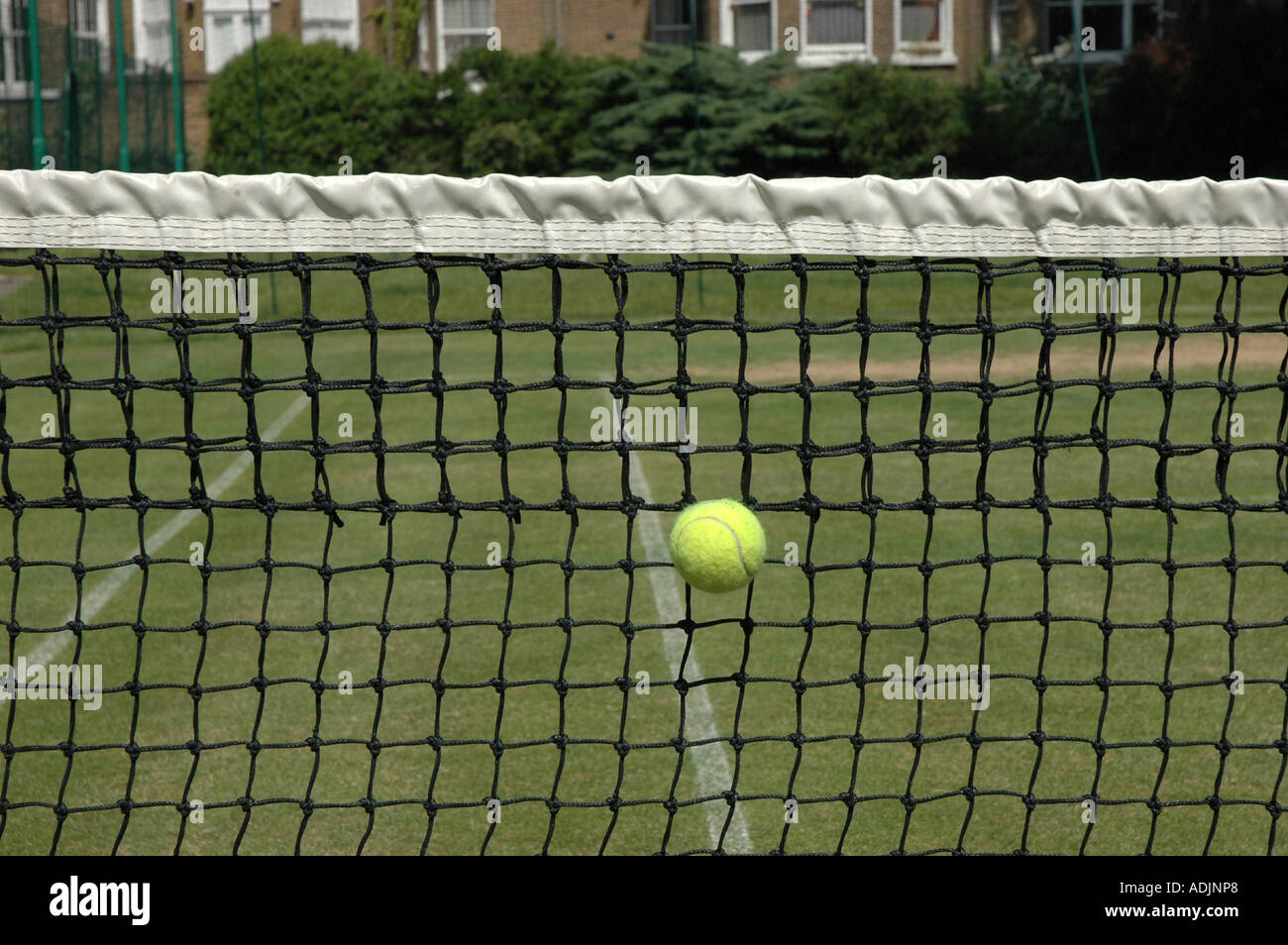 Tennis ball hitting the net Stock Photo