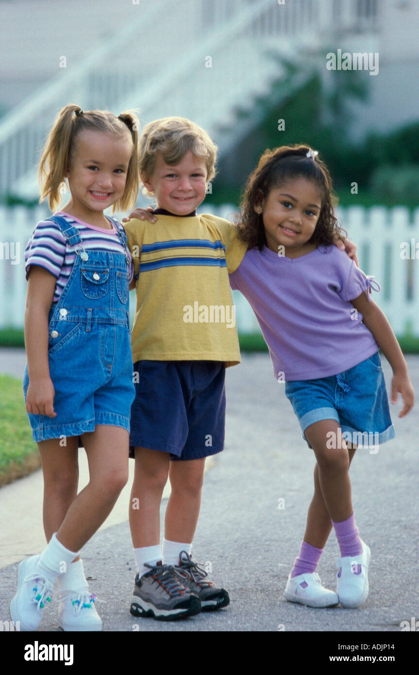 Portrait of two girls and a boy standing together Stock Photo - Alamy