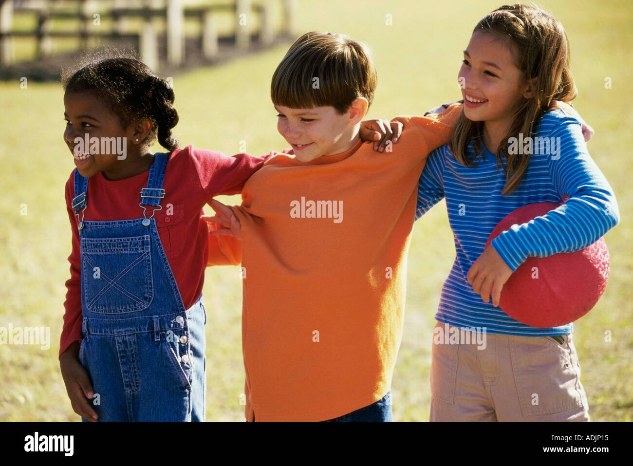 Two girls and a boy standing together Stock Photo - Alamy