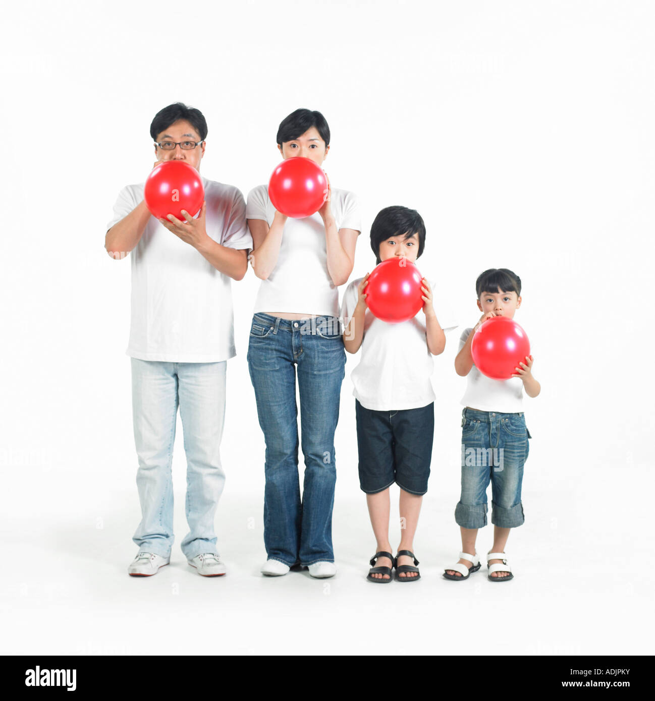 A Korean family is blowing red balloons Stock Photo Alamy
