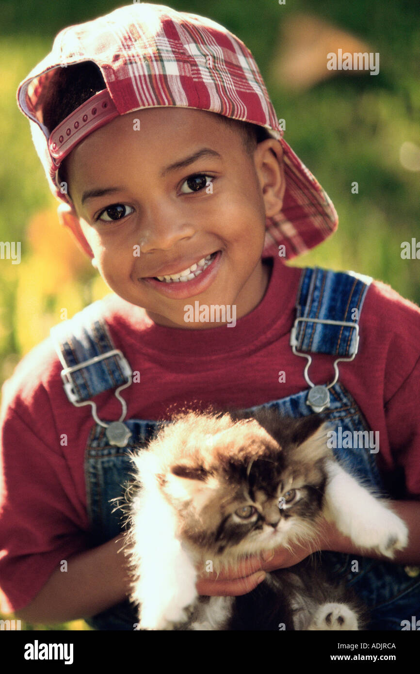 Portrait of a boy holding a cat Stock Photo