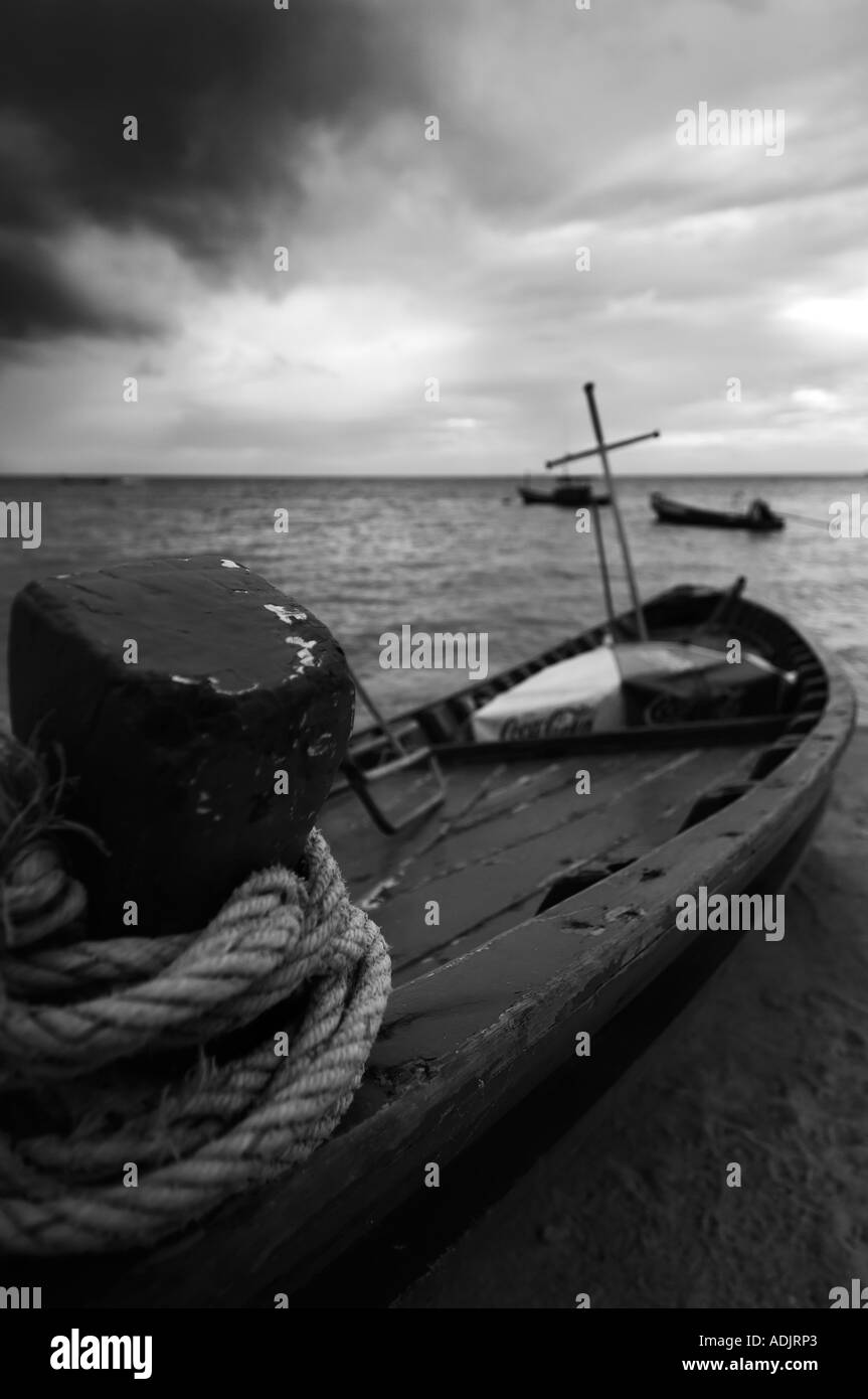 A Thai longtail is beached ready for repairs Stock Photo