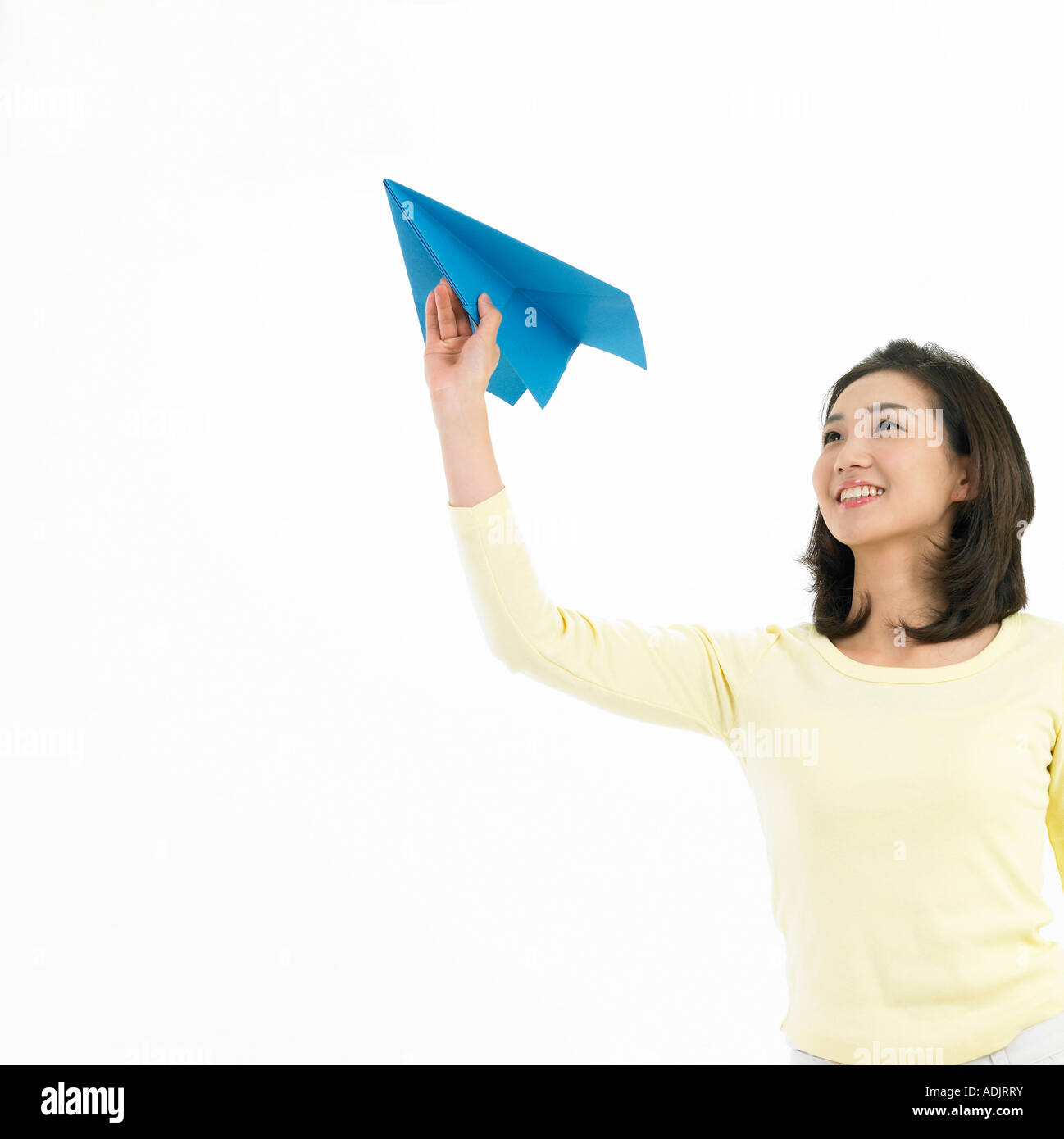 A woman is flying a blue paper airplane Stock Photo - Alamy