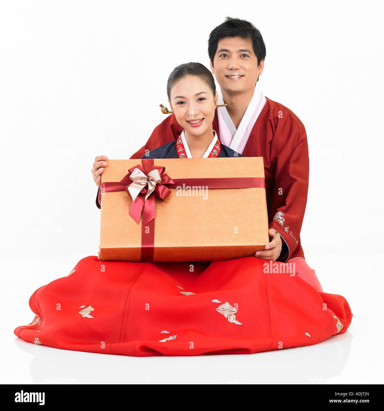 A new married couple wearing Hanboek is holding a gift box Stock Photo