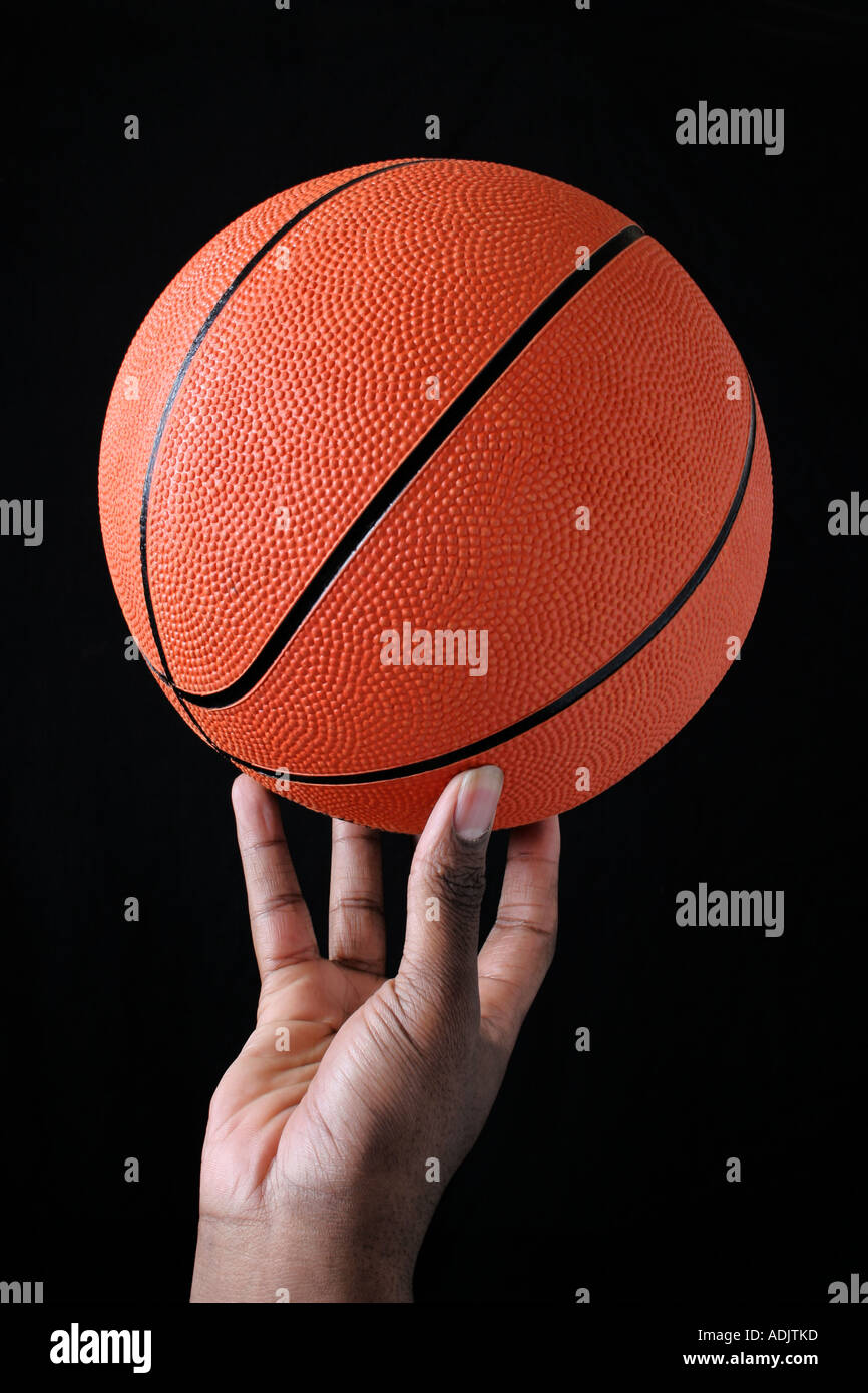 Hand holding a basketball Stock Photo