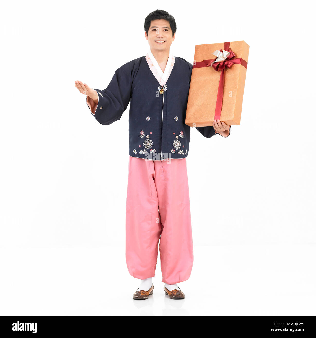 A Korean man wearing Hanboek is holding a gift box Stock Photo