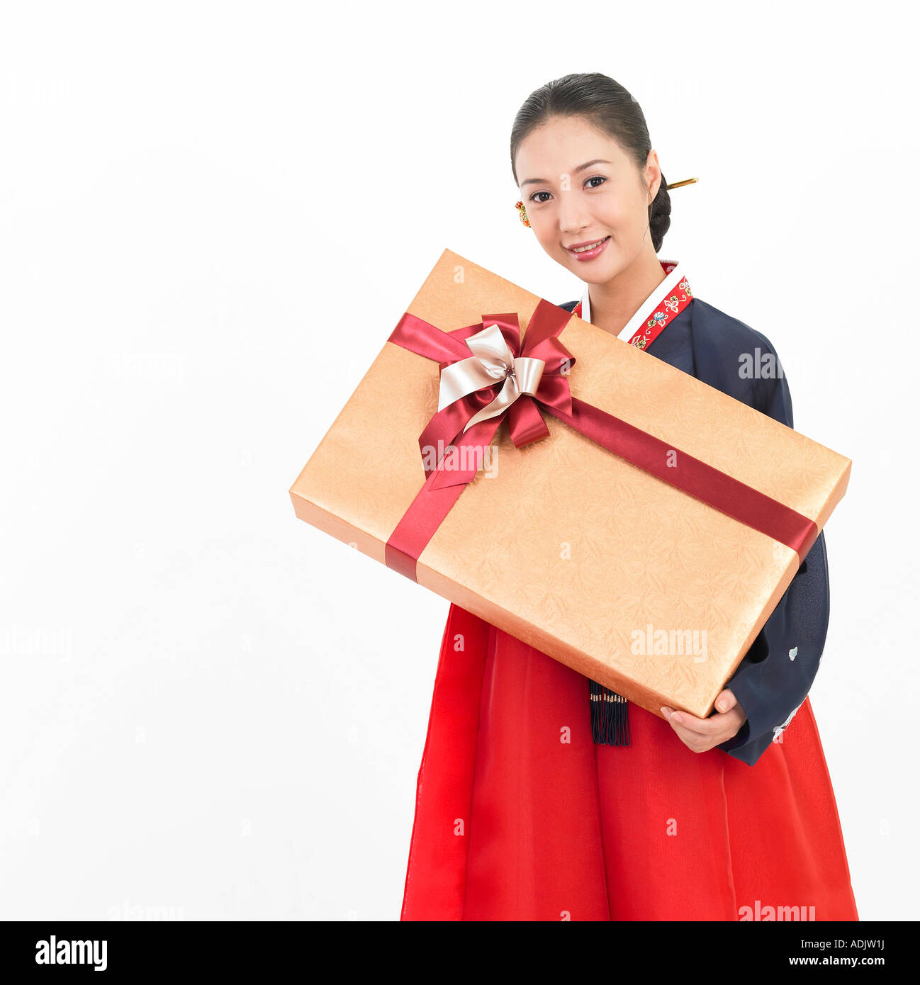 A Korean woman wearing Hanboek is holding a gift box Stock Photo