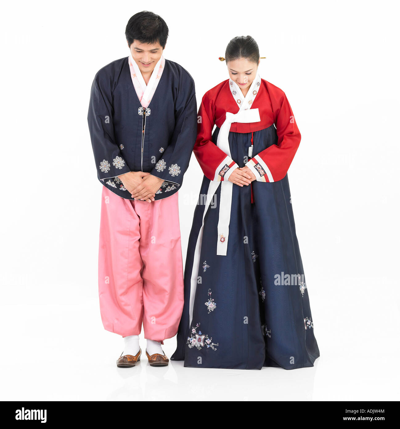 A Korean couple wearing Hanboek is bowing Stock Photo - Alamy