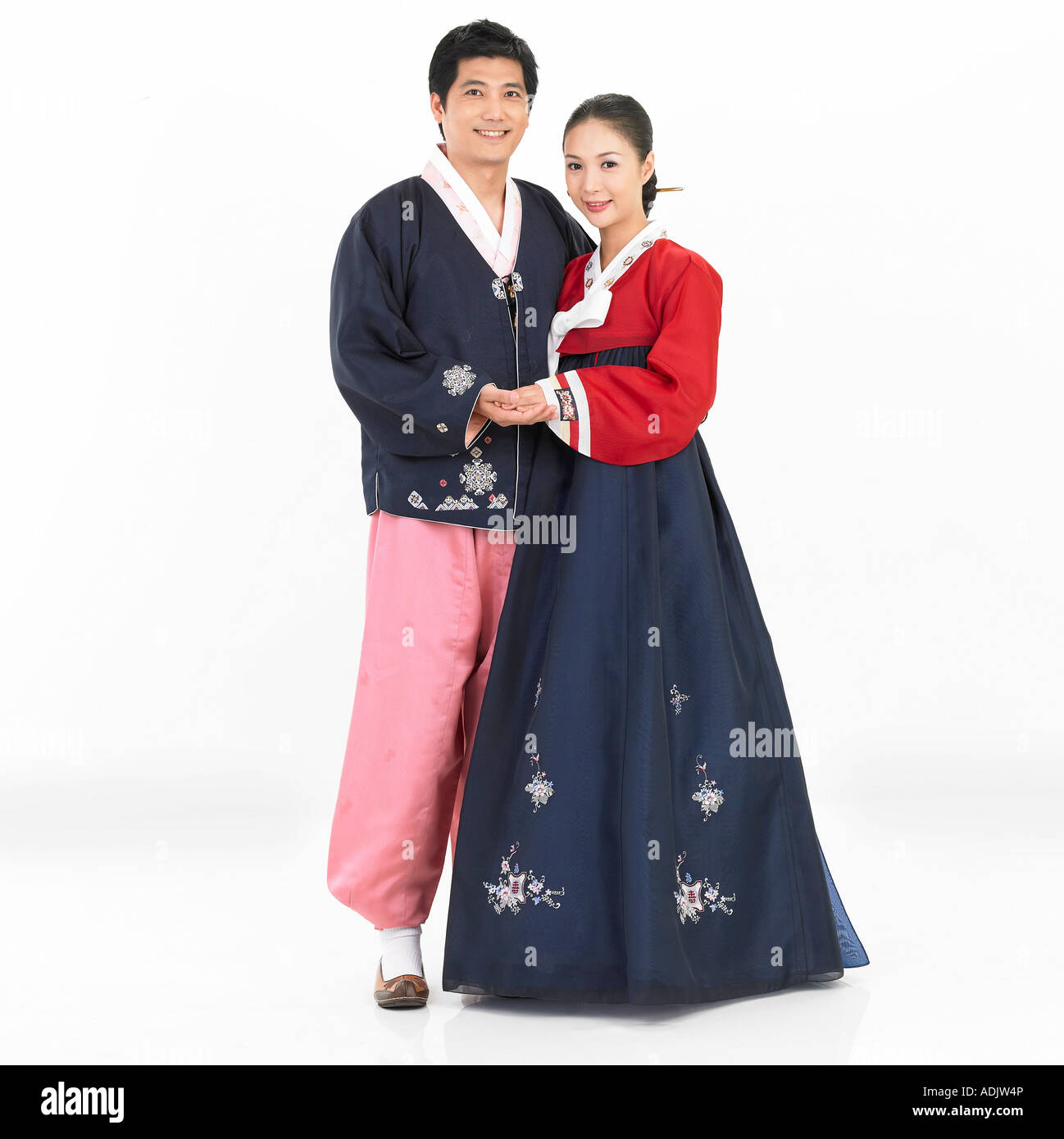 A Korean couple wearing Hanboek is holding hands each other Stock Photo
