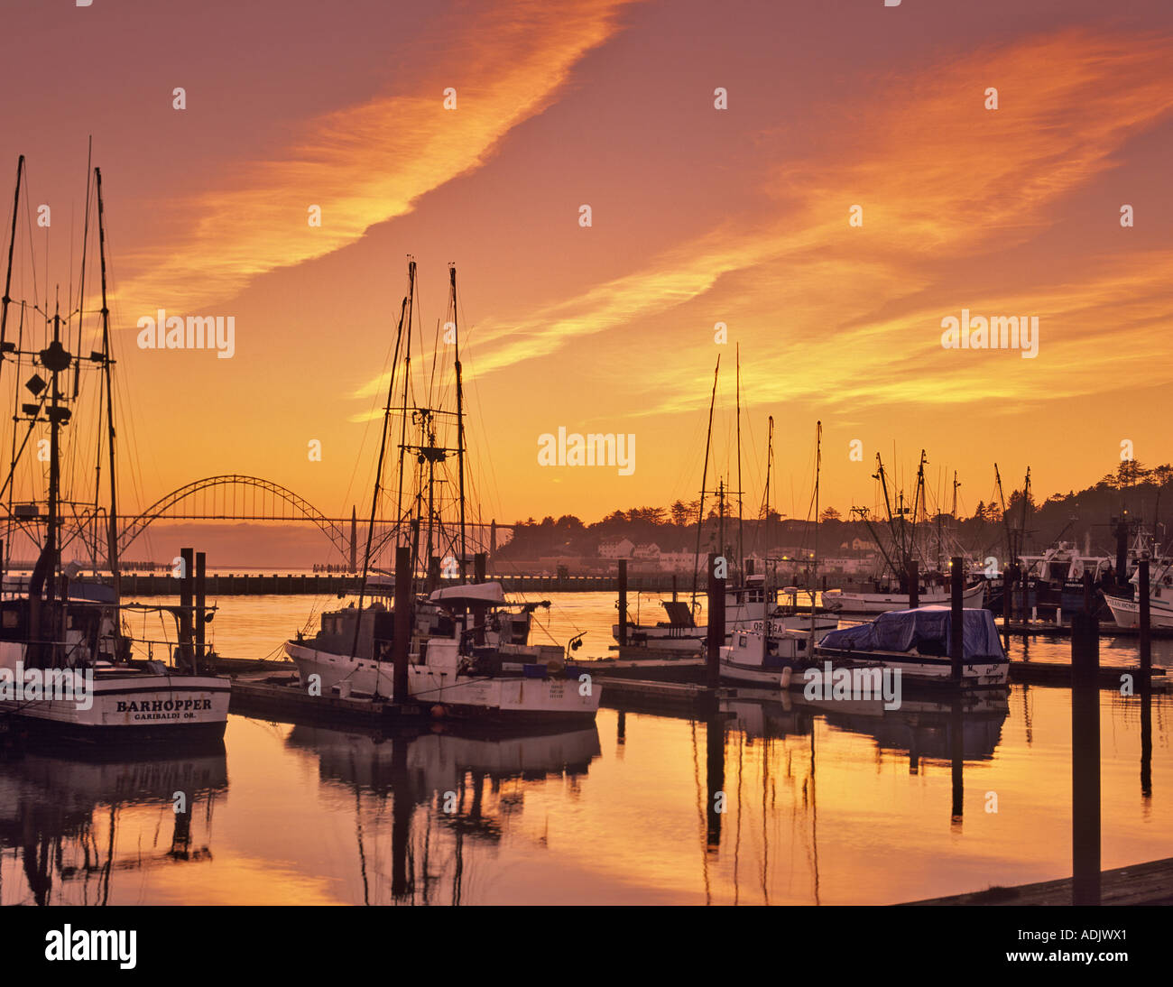 Yaquina Bay Harbor boats at sunset Oregon Stock Photo