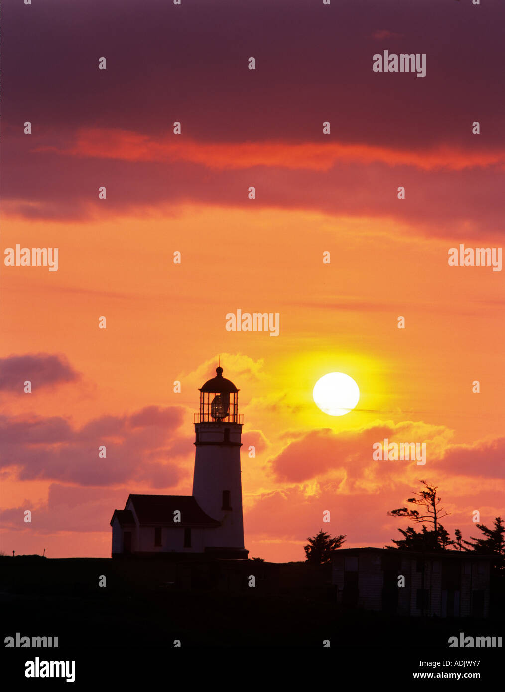 Cape Blanco Lighthouse with setting sun Oregon Stock Photo