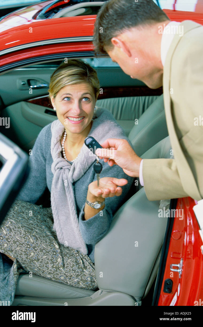 Smiling salesman holding car hi-res stock photography and images - Alamy