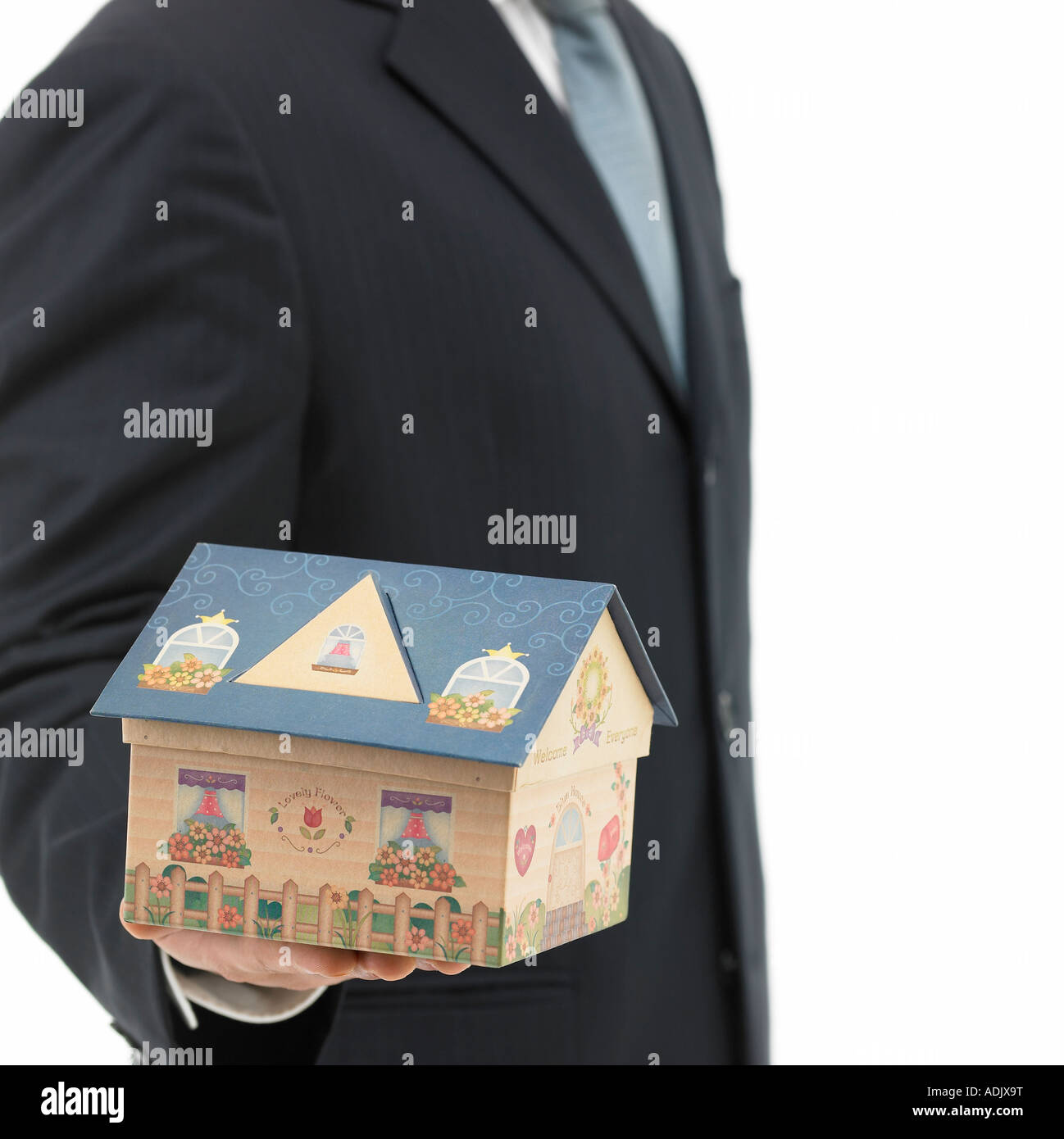 A man holding up a model house Stock Photo - Alamy