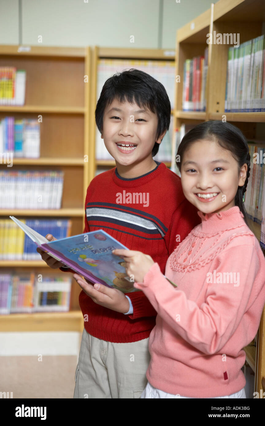 A girl and a boy in the library Stock Photo - Alamy