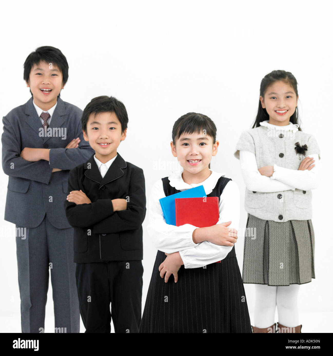 boys and a girl folding their arms, a girl holding books Stock Photo ...