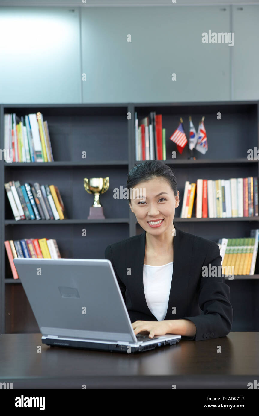 a businesswoman sitting at the desk Stock Photo - Alamy