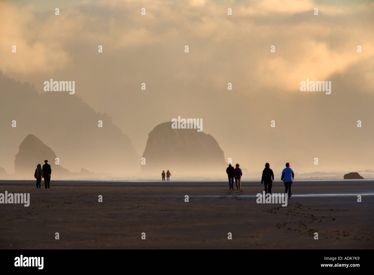 Couples walking on Cannon Beach Oregon Stock Photo